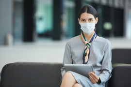 Businesswoman Wearing Mask in Waiting Lounge linkedin marketing